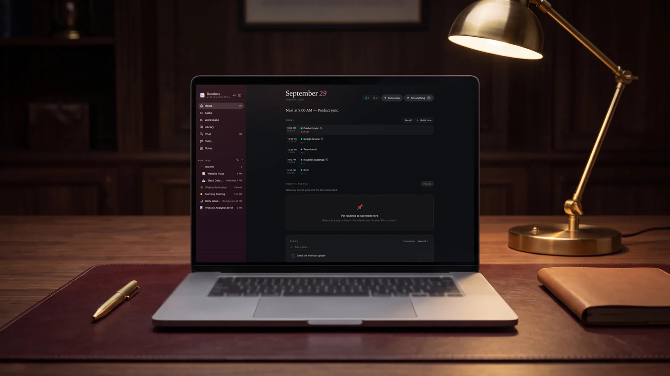 A laptop under a desk lamp at night showing Routines in the Burgundy theme, dark mode
